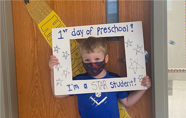 This picture is of GP on his first day of HP Preschool holding a first day sign.